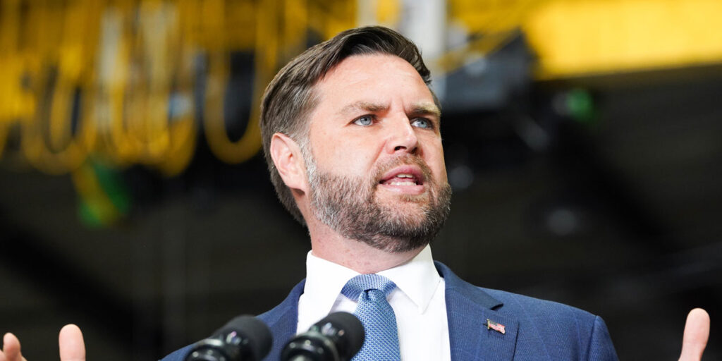 Vice President JD Vance speaks in front of a podium.