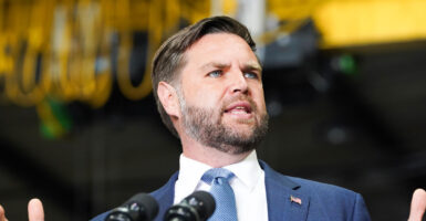 Vice President JD Vance speaks in front of a podium.