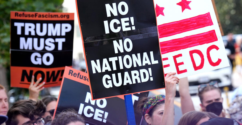 crowds protest Trump taking over the Washington, DC, police force with signs that read no National Guard and Trump must go