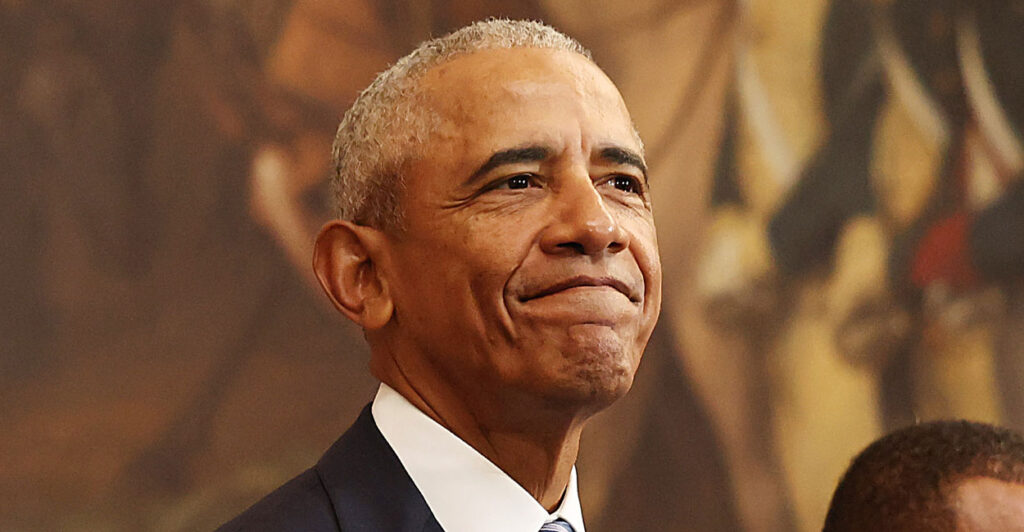 Barack Obama in a suit smiling