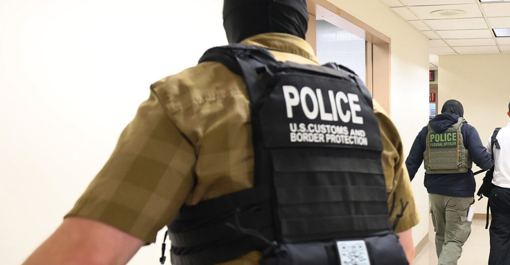 A Customs and Border Protection police officer, seen from behind