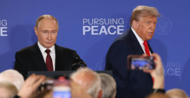 Russian President Vladimir Putin (left) and President Donald Trump enter the hall for their joint press conference after their meeting on the Russia-Ukraine war at a U.S. air base In Alaska on Friday.