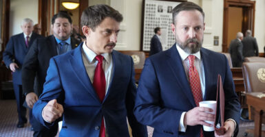 Republican state Rep. Briscoe Cain (left) and Speaker of the House Dustin Burrows leave the Texas House floor after a quorum call failed on Aug. 8.