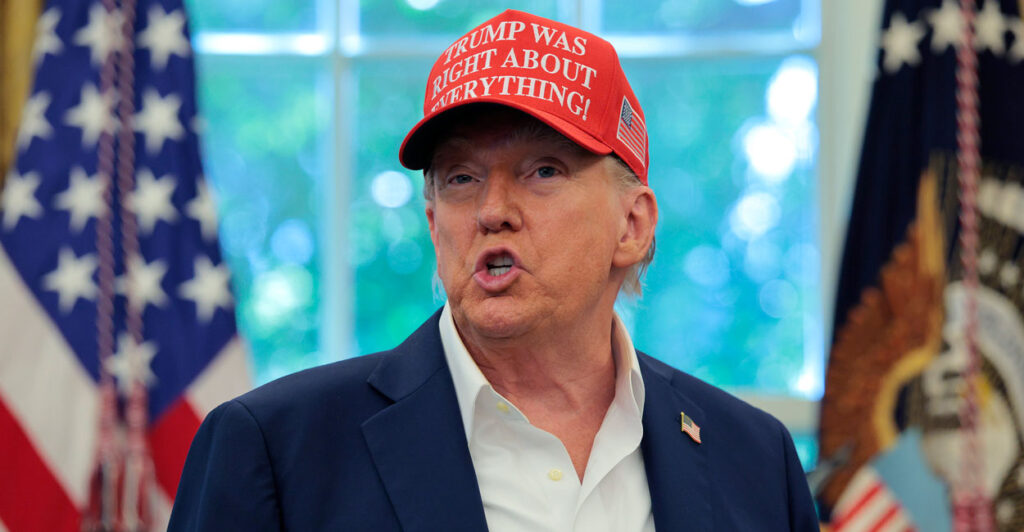 President Donald Trump, wearing a hat and no tie, speaks in the Oval Office. (Chip Somodevilla/Getty Images)