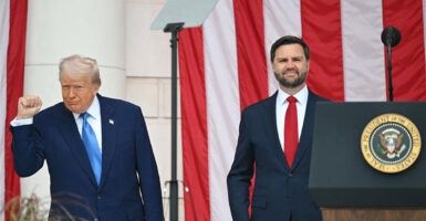 President Donald Trump gestures with a fist pump while Vice President JD Vance smiles.