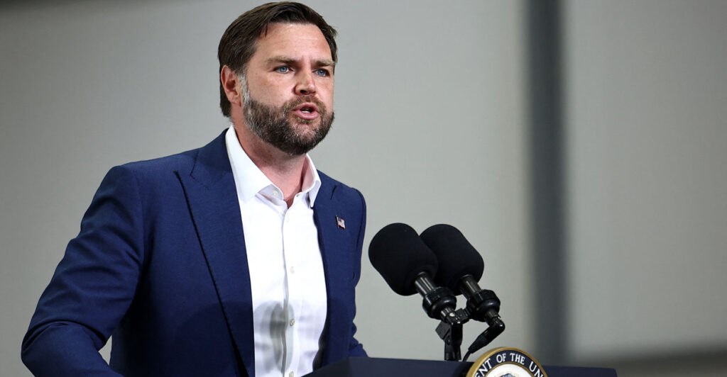 Vice President JD Vance stands at a lectern, delivering a speech in southwest England on Aug. 13.