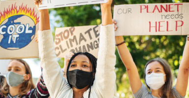 Climate change protesters hold up signs such as stop climate change