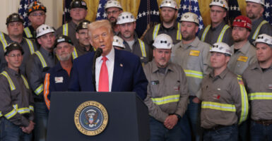 U.S. President Donald Trump speaks alongside coal and energy workers.