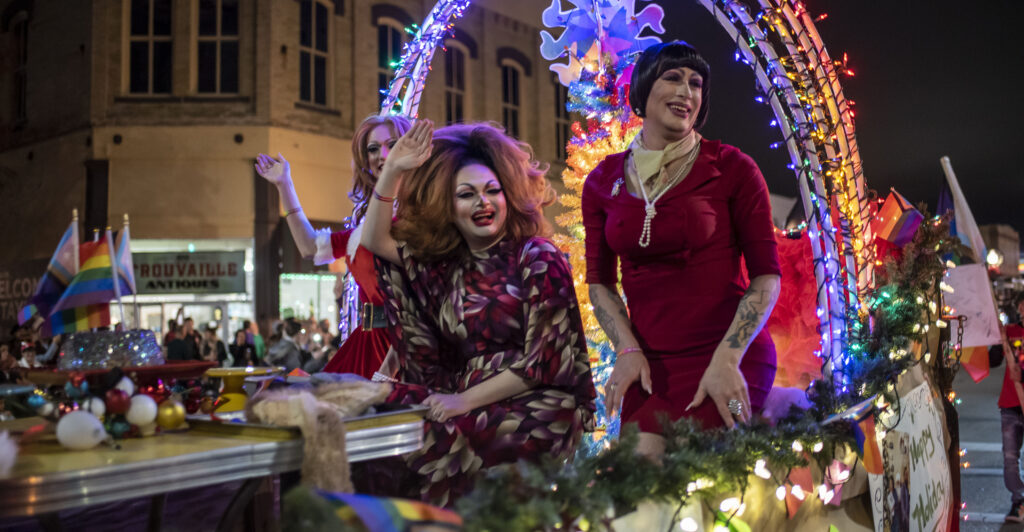 Drag queens Felicia Enspire, Alexandria Van Cartier and Sedonya Face sit on a float at a Christmas parade on Saturday, Dec 3 in Taylor, TX.