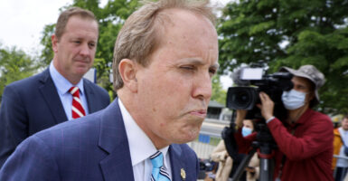 Texas Attorney General Ken Paxton (C) and Missouri Attorney General Eric Schmitt (L) arrive for a news conference after the U.S. Supreme Court heard arguments in their case about Title 42 on April 26, 2022 in Washington, DC.