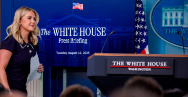 Presidential press secretary Karoline Leavitt approaches the lectern in the White House press briefing room.