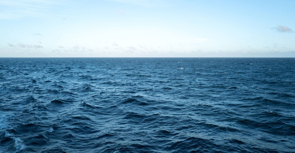 The waves in the open ocean in the middle of the day.