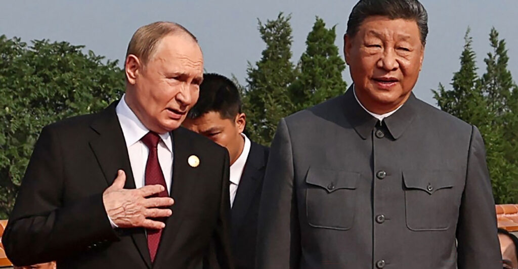 Russian President Vladimir Putin confers with Chinese President Xi Jinping in Beijing's Tiananmen Square on Wednesday.