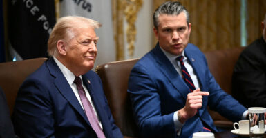 President Donald Trump looks on as Defense Secretary Pete Hegseth speaks during a Cabinet meeting at the White House on Aug. 26.