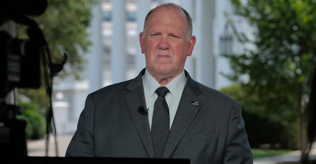 Tom Homan, with White House in the background, glaring.