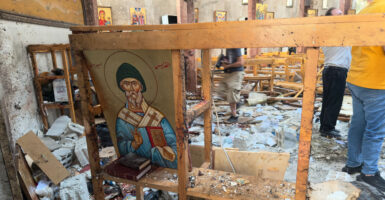 Rescue workers and civilians on June 22 inspect the aftermath of a suicide bombing at St. Elias Greek Orthodox Church in Damascus, Syria.