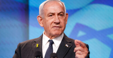 Benjamin Netanyahu gestures while delivering a speech.