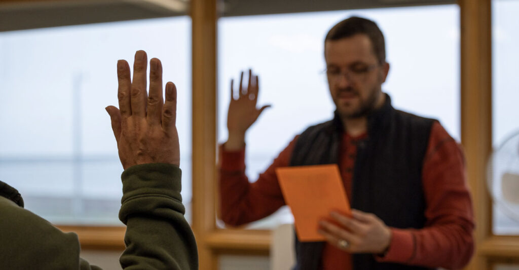 A U.S. Citizenship and Immigration Services officer leads an immigrant from Thailand in the oath of allegiance to the United States after the applicant passed his naturalization exam, in Utqiagvik, Alaska, on Aug. 9, 2023.