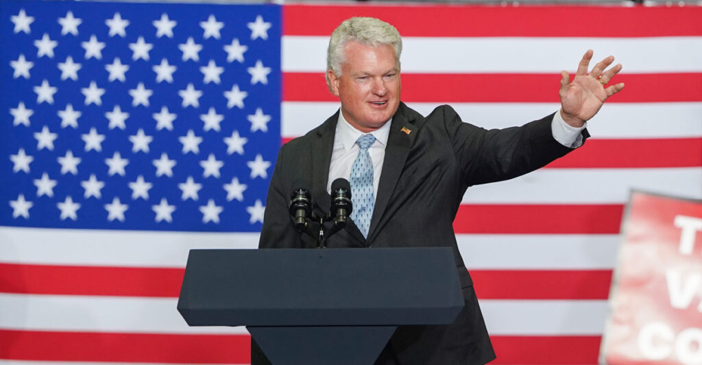 With an American flag as backdrop, Rep. Mike Collins, R-Ga., speaks to supporters of President Donald Trump at an event hosted by Vice President JD Vance on Aug. 21 in Peachtree City, Georgia.