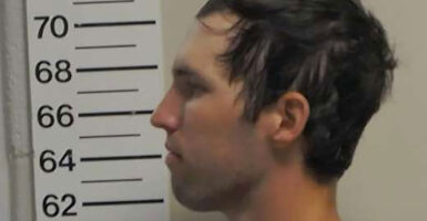 A police mugshot in profile of Tyler Robinson, the lead suspect in Charlie Kirk shooting