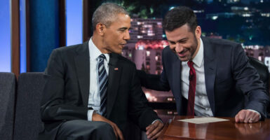 Jimmy Kimmel puts his arm on Barack Obama as they chat on the set of Kimmel's TV show.