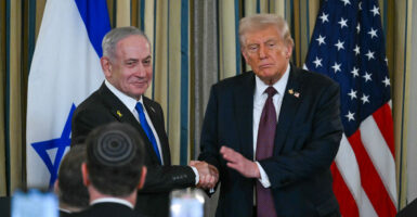 President Donald Trump and Israeli Prime Minister Benjamin Netanyahu shaking hands.