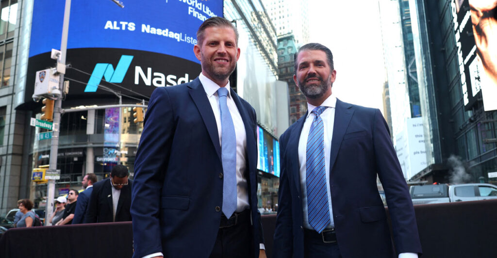 Donald Trump Jr. and Eric Trump stand together outside Nasdaq in New York Times Square.