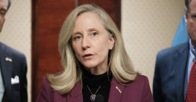 Abigail Spanberger in a suit with a Ukraine and U.S. flag pin.