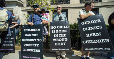 Supporters of anti-trans activist Chris Elston demonstrate against gender affirmation treatments and surgeries on minors.