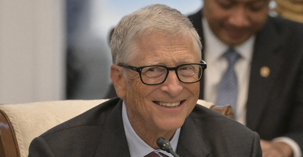 Microsoft Founder Bill Gates smiles in a suit.