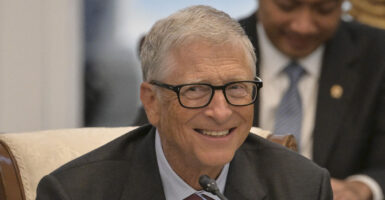 Microsoft Founder Bill Gates smiles in a suit.