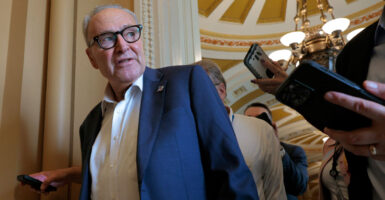 Chuck Schumer walks through the Capitol.