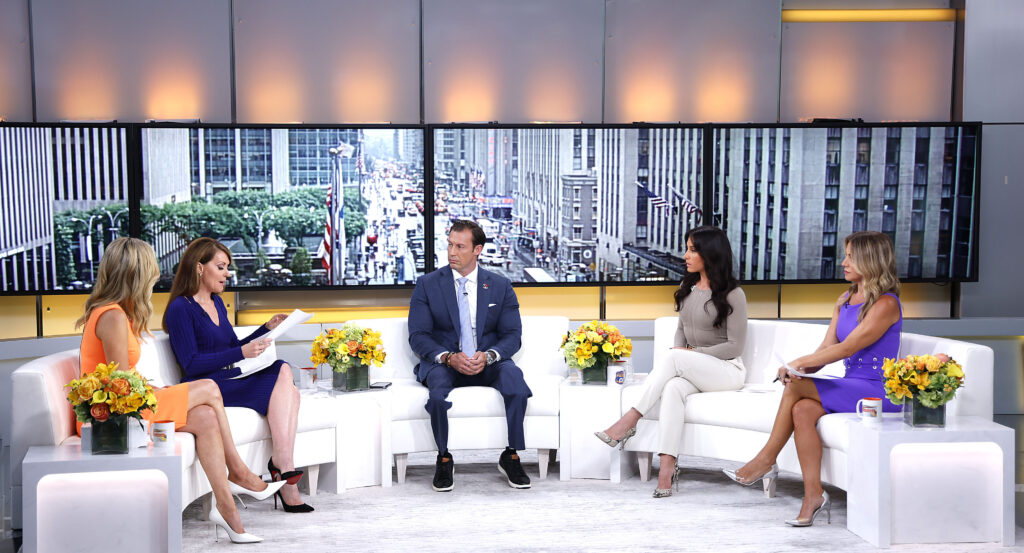 Joey Jones, Kayleigh McEnany, Dagen McDowell, Emily Compagno and Dr. Nicole Saphier are sitting on a white sofa.