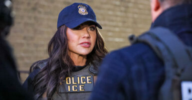 Homeland Security chief Kristi Noem speaks to ICE agents while wearing an ICE uniform and bulletproof vest.