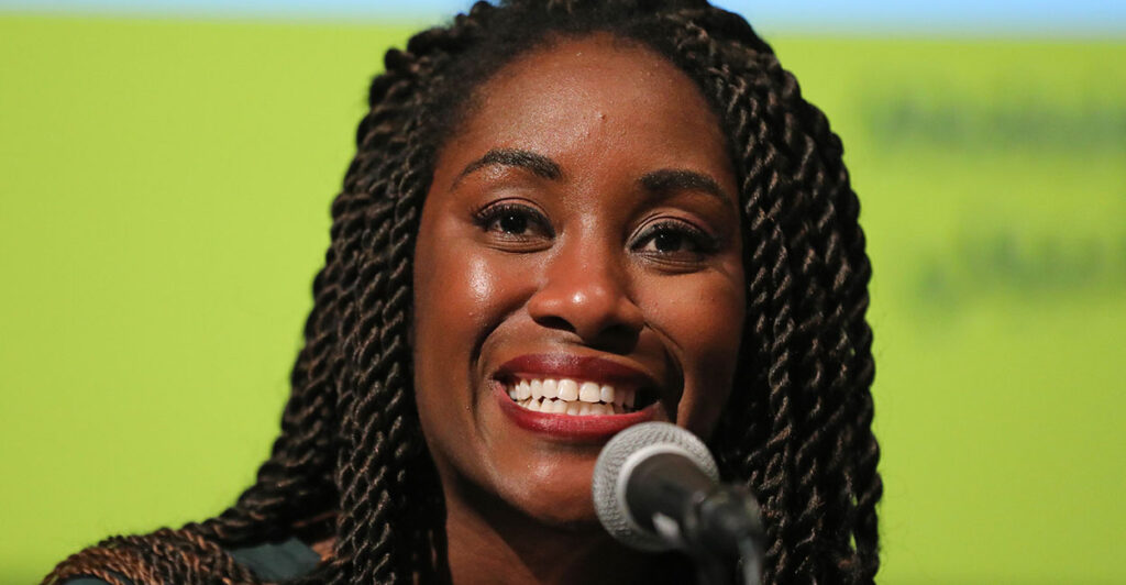 Karen Attiah behind a microphone