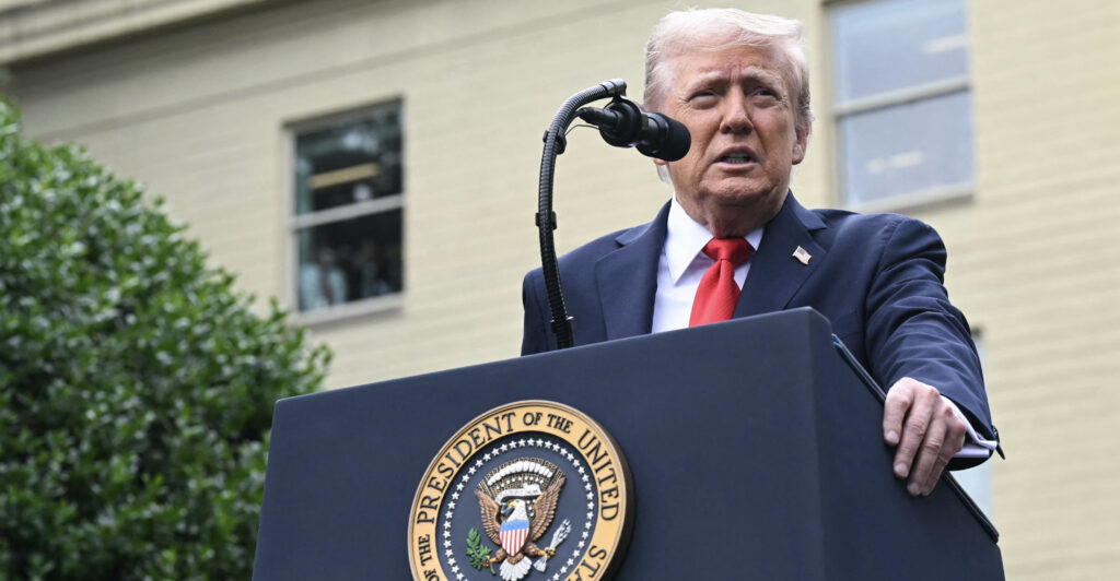 President Donald Trump behind a podium with the Pentagon behind him.