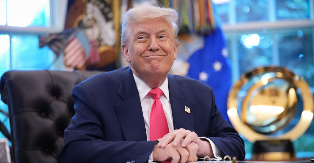 President Donald Trump in a blue suit with a pink tie at the White House