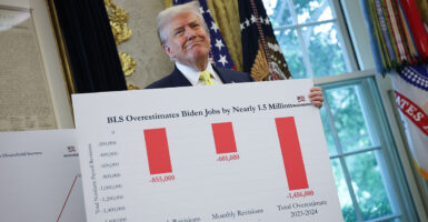 Trump holds a sign with BLS numbers