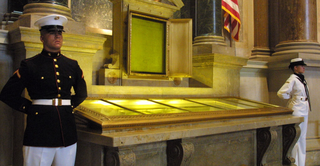 An honor guard stands next to the original copies of the Declaration of Independence, the Constitution and the Bill of Rights July 4, 2001 at the National Archives in Washington, D. C.