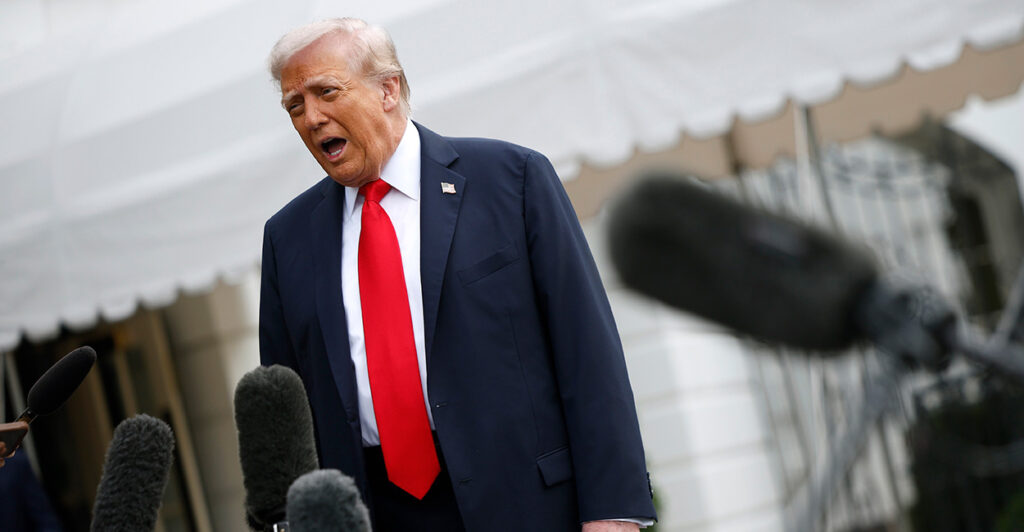 Trump speaks to reporters in front of the White House.
