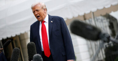 Trump speaks to reporters in front of the White House.