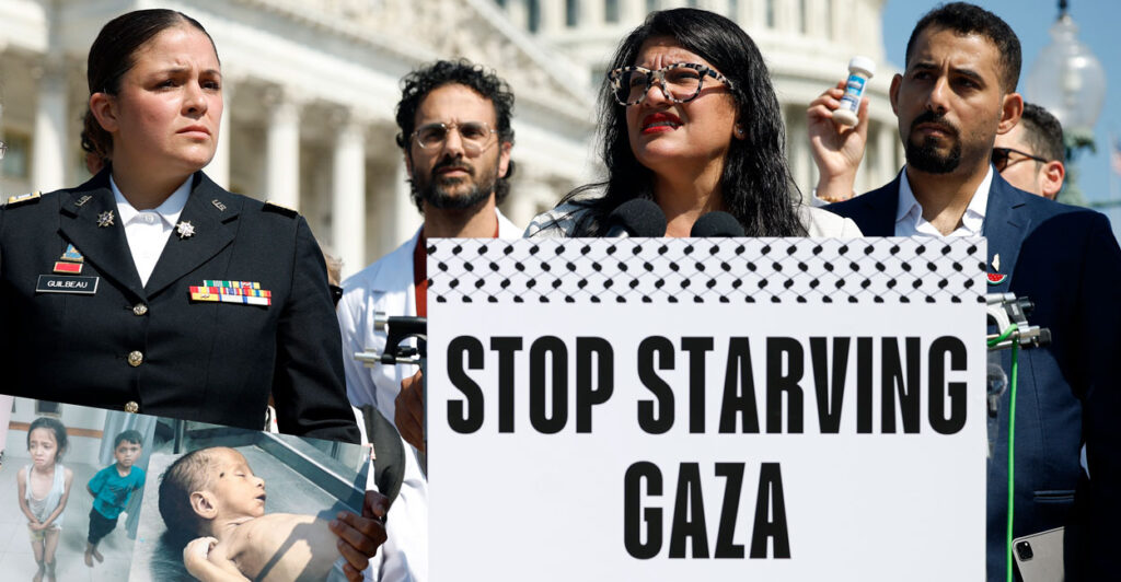 Rep. Rashida Tlaib, joined by pro-Palestinian activists, speaks at a press conference on food aid to Gaza, outside the U.S. Capitol. A sign on the lectern says, “Stop Starving Gaza.”