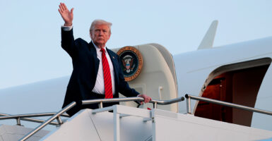 Donald Trump waves as he boards Air Force One