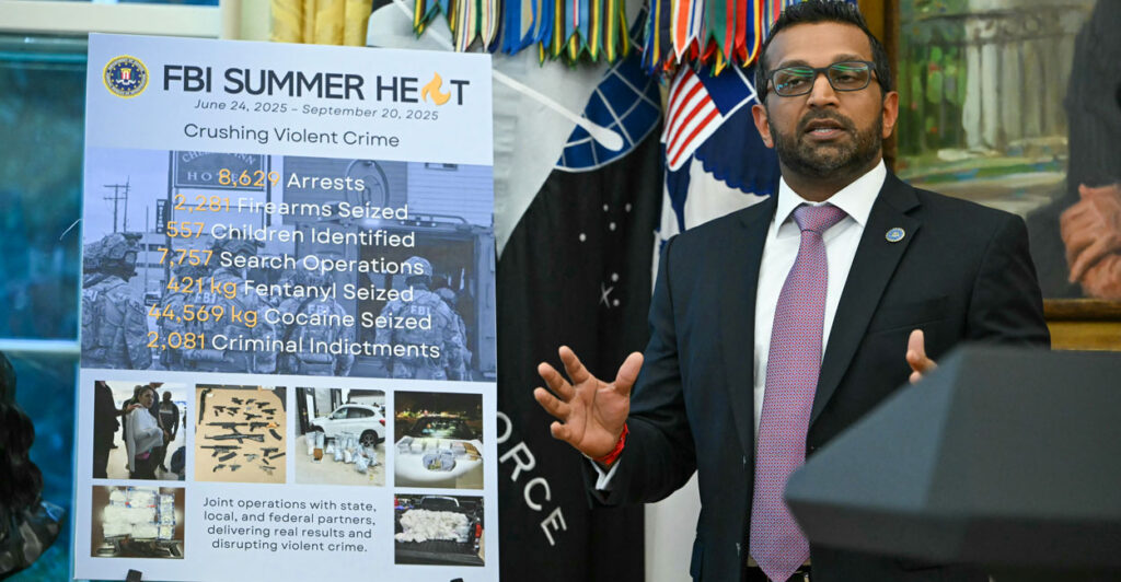 At a press conference with President Donald Trump at the White House on Wednesday, FBI Director Kash Patel speaks next to a poster detailing the anti-crime accomplishments of the bureau's Operation Summer Heat.