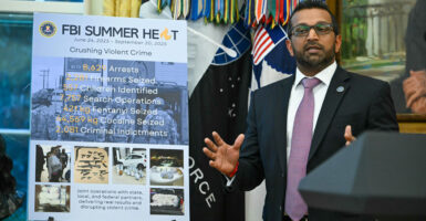 At a press conference with President Donald Trump at the White House on Wednesday, FBI Director Kash Patel speaks next to a poster detailing the anti-crime accomplishments of the bureau's Operation Summer Heat.