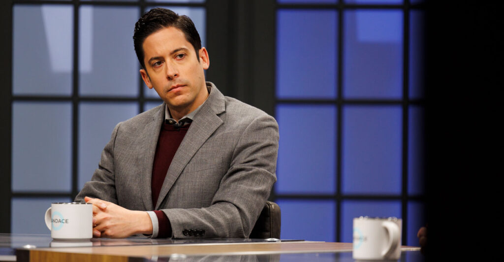 Conservative commentator Michael Knowles is seen here on Jan. 11, 2022, in Nashville, Tenn., seating behind a desk with a coffee mug in front of him.