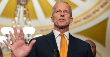 Senate Majority Leader John Thune, R-S.D., speaks at a news conference on Tuesday, holding out an open palm as if to tell Democrats to stop.