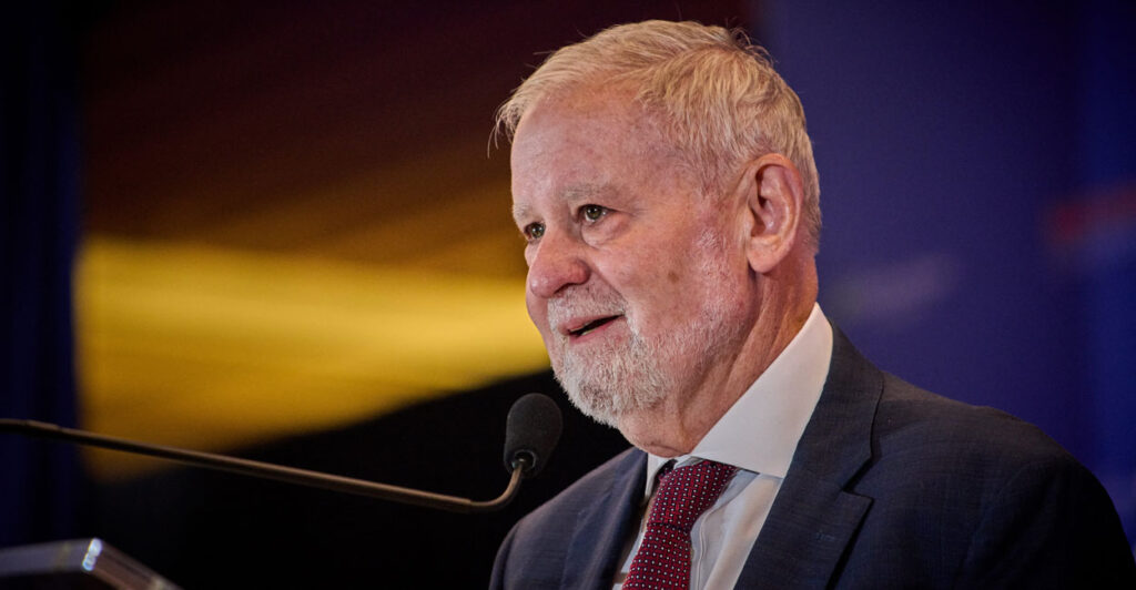 Close-up of Hillsdale College President Larry Arnn speaking into a microphone.