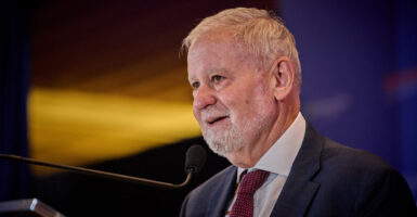 Close-up of Hillsdale College President Larry Arnn speaking into a microphone.