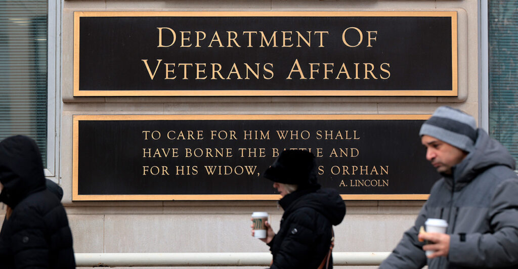 People walk past the Department of Veterans Affairs headquarters in Washington, D.C., on March 6.